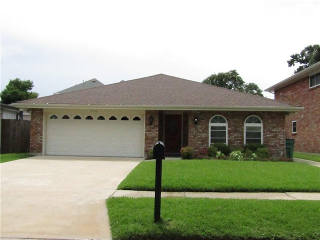4908 Wills St, Metairie, LA 70006 - ranch-style house with a garage, concrete driveway, a front lawn, and brick siding