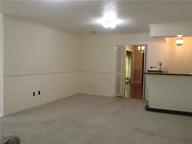 4908 Wills St, Metairie, LA 70006 - unfurnished room featuring a chandelier, carpet floors, and ornamental molding