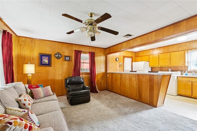 638 Huntlee Dr, New Orleans, LA 70131 - living room featuring ceiling fan, light colored carpet, washer / clothes dryer, and wood walls