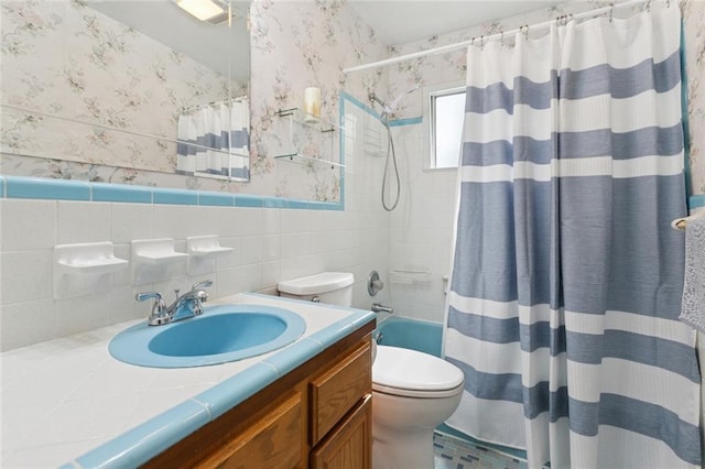 638 Huntlee Dr, New Orleans, LA 70131 - full bath with wallpapered walls, vanity, tile walls, a wainscoted wall, and shower / bath combo