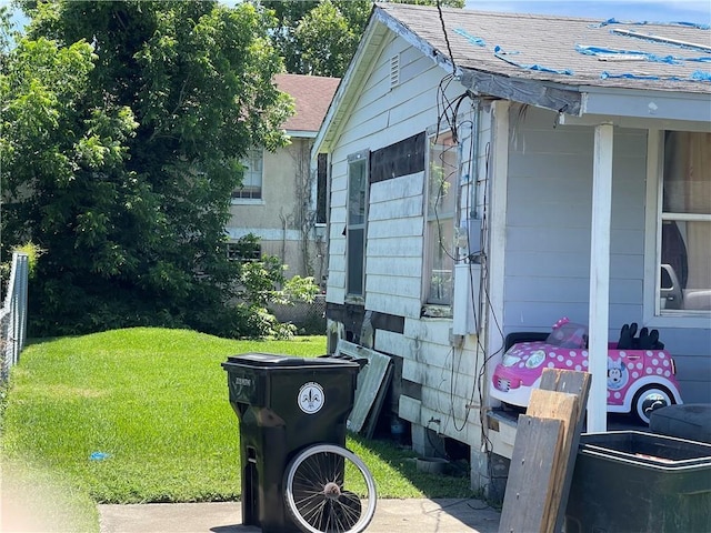 2709 Cherry St, New Orleans, LA 70118 - view of side of property with a lawn and roof with shingles