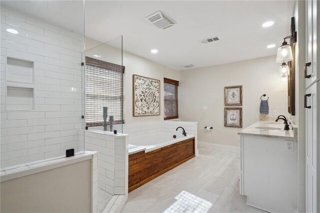 133 Crapemyrtle Rd, Covington, LA 70433 - full bathroom with vanity, a bath, walk in shower, marble look tiles, and recessed lighting