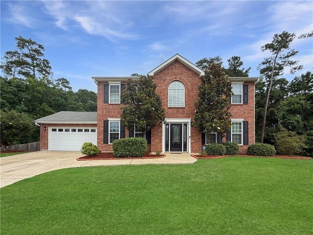2009 Rubich Ln, Slidell, LA 70461 - colonial home with a garage, concrete driveway, and brick siding