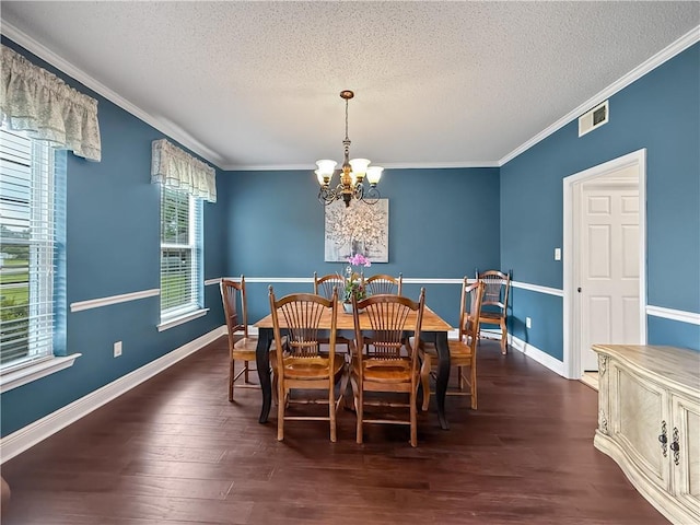 2009 Rubich Ln, Slidell, LA 70461 - dining room with a chandelier, a textured ceiling, ornamental molding, and wood finished floors