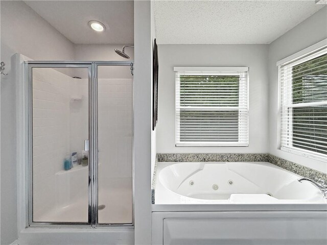 2009 Rubich Ln, Slidell, LA 70461 - full bathroom with a shower stall, a tub with jets, and a textured ceiling