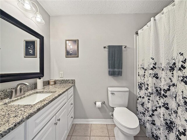 2009 Rubich Ln, Slidell, LA 70461 - bathroom featuring vanity, a textured ceiling, tile patterned flooring, and a shower with curtain