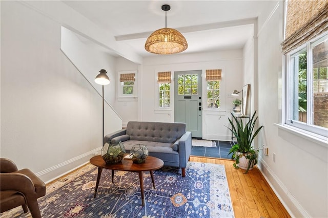 1016 Constantinople St, New Orleans, LA 70115 - living area with healthy amount of natural light, wood finished floors, and beam ceiling