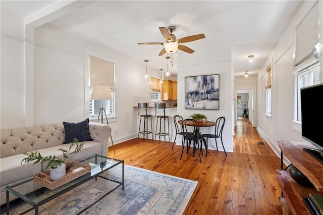 1016 Constantinople St, New Orleans, LA 70115 - living area with light wood-style flooring and a ceiling fan