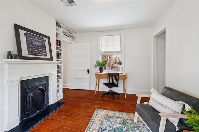 1016 Constantinople St, New Orleans, LA 70115 - office area with wood finished floors and a fireplace with raised hearth