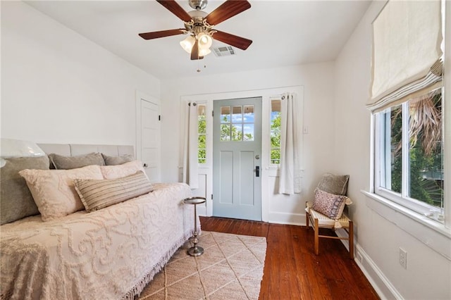 1016 Constantinople St, New Orleans, LA 70115 - bedroom featuring multiple windows, hardwood / wood-style flooring, and a ceiling fan