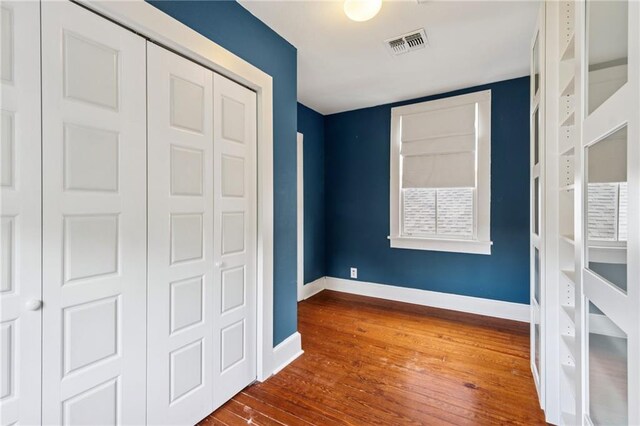 1016 Constantinople St, New Orleans, LA 70115 - unfurnished bedroom with wood-type flooring and a closet