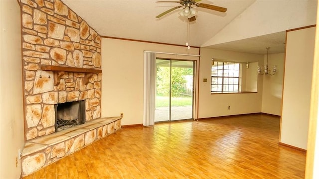 232 Lake Village Blvd, Slidell, LA 70461 - unfurnished living room featuring a fireplace, vaulted ceiling, ceiling fan, wood finished floors, and a chandelier