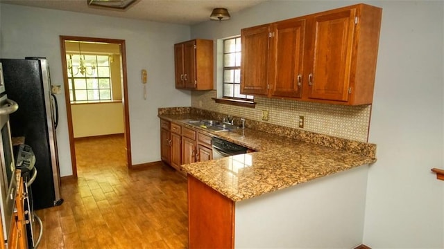 232 Lake Village Blvd, Slidell, LA 70461 - kitchen featuring decorative backsplash, appliances with stainless steel finishes, light wood-style floors, and plenty of natural light