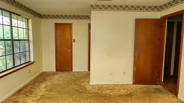 232 Lake Village Blvd, Slidell, LA 70461 - carpeted empty room featuring plenty of natural light and a textured ceiling