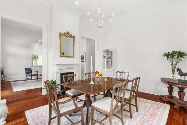 417 Eleonore St, New Orleans, LA 70115 - dining room featuring a chandelier, wood finished floors, crown molding, and a fireplace