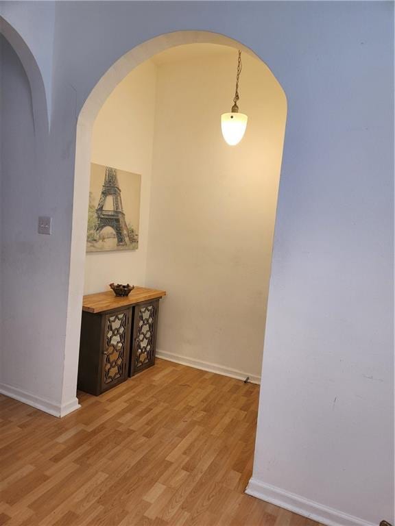 2715 Marengo St, New Orleans, LA 70115 - hallway with light wood-style floors and arched walkways