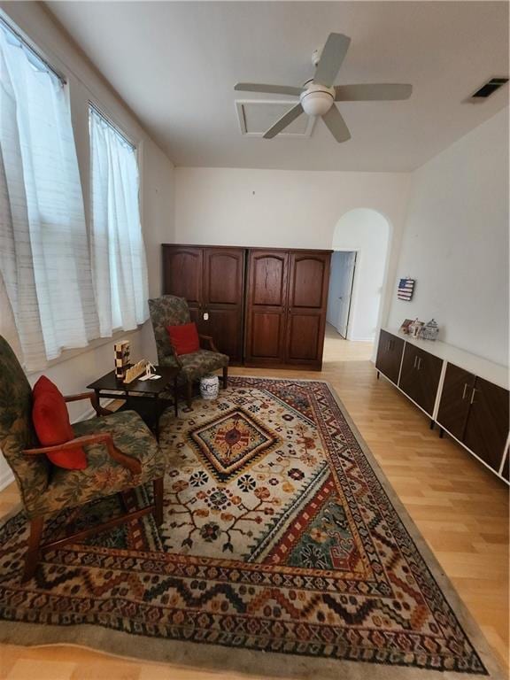 2715 Marengo St, New Orleans, LA 70115 - sitting room with light wood-style floors, ceiling fan, and arched walkways