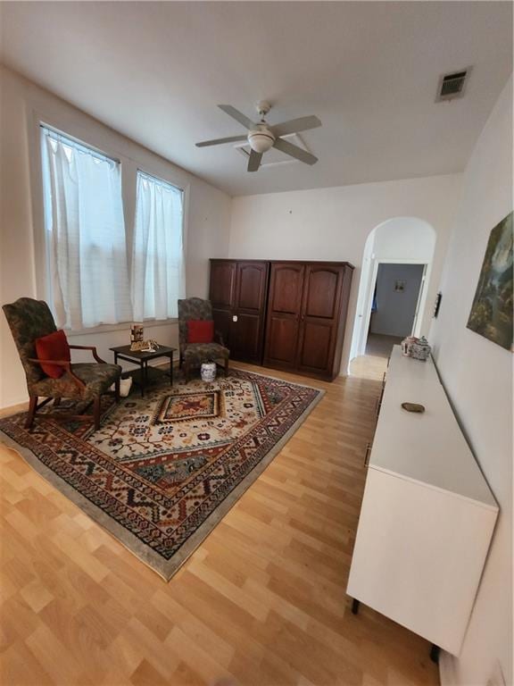 2715 Marengo St, New Orleans, LA 70115 - sitting room featuring light wood-style floors, ceiling fan, and arched walkways