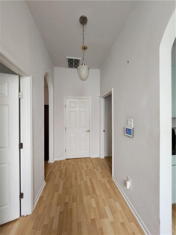2715 Marengo St, New Orleans, LA 70115 - hall with arched walkways and light wood finished floors