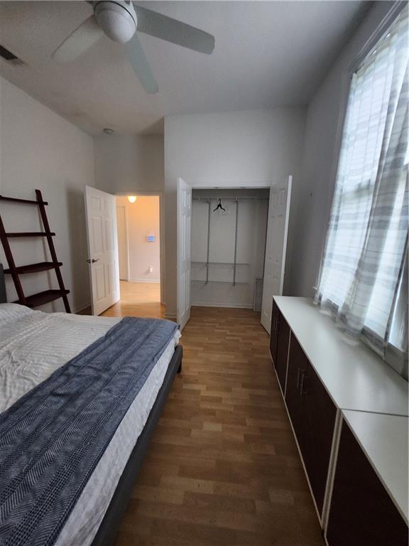 2715 Marengo St, New Orleans, LA 70115 - bedroom featuring wood finished floors, a closet, and a ceiling fan