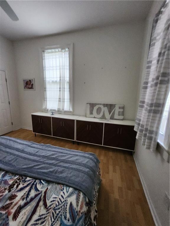 2715 Marengo St, New Orleans, LA 70115 - bedroom featuring multiple windows, wood finished floors, and ceiling fan