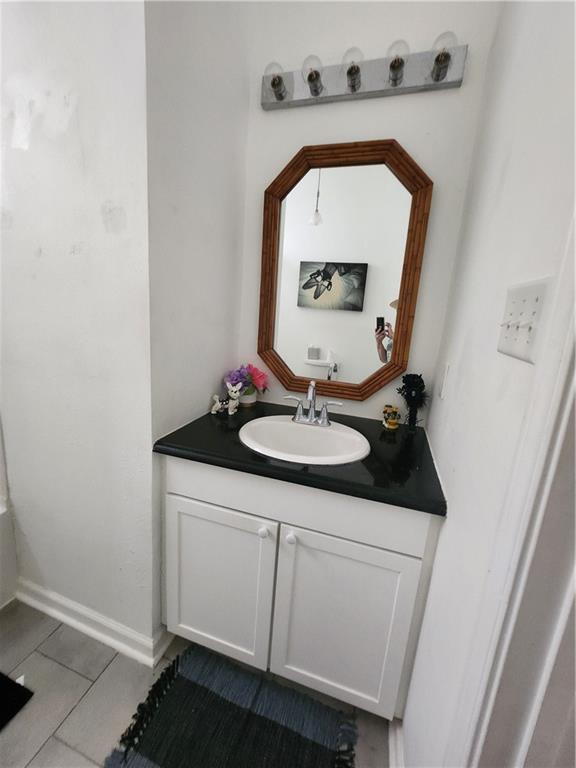 2715 Marengo St, New Orleans, LA 70115 - bathroom with vanity and tile patterned flooring