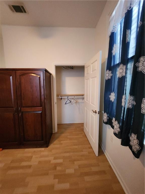 2715 Marengo St, New Orleans, LA 70115 - hallway featuring light wood-style floors and baseboards