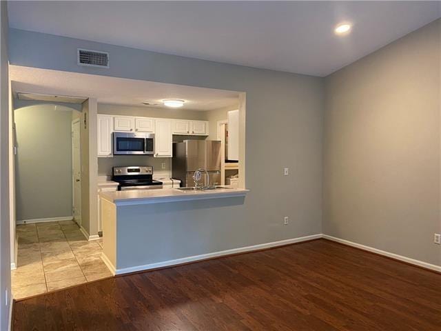 350 Emerald Forest Ave Unit 5202, Covington, LA 70433 - kitchen with appliances with stainless steel finishes, white cabinets, light wood finished floors, light countertops, and recessed lighting