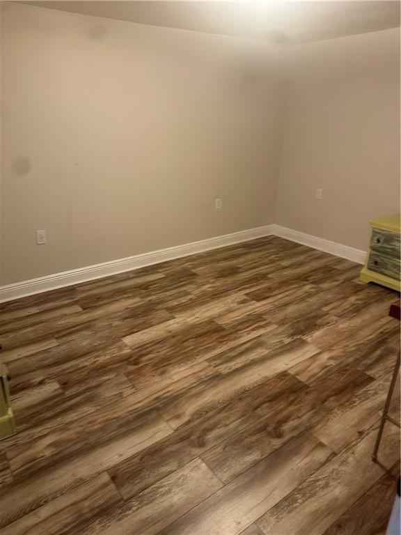 105 Beta St, Belle Chasse, LA 70037 - empty room featuring dark wood-style flooring and baseboards