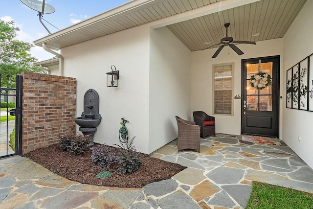 246 S Orchard Ln, Covington, LA 70433 - doorway to property with ceiling fan and stucco siding