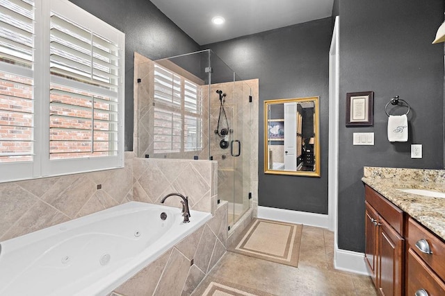 246 S Orchard Ln, Covington, LA 70433 - full bathroom featuring a whirlpool tub, a stall shower, vanity, and tile patterned floors