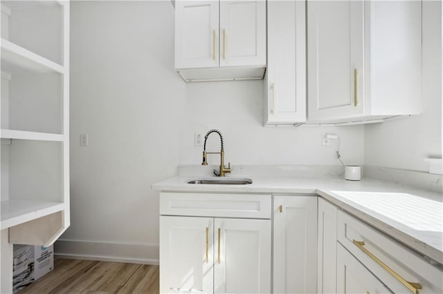 59 Oak Tree Dr, Slidell, LA 70458 - kitchen with white cabinetry and light wood finished floors