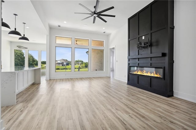 59 Oak Tree Dr, Slidell, LA 70458 - unfurnished living room with light wood-style floors, a large fireplace, recessed lighting, and ceiling fan