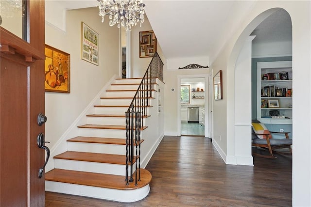 223840 Dante St, New Orleans, LA 70118 - entrance foyer with arched walkways, wood finished floors, stairway, and a chandelier