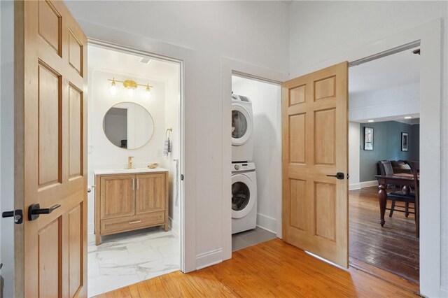 223840 Dante St, New Orleans, LA 70118 - laundry room featuring stacked washer / dryer and light wood finished floors
