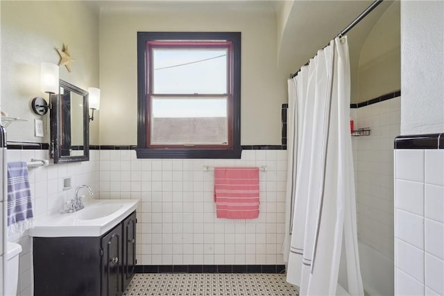 223840 Dante St, New Orleans, LA 70118 - full bath featuring tile walls, vanity, wainscoting, shower / bathtub combination with curtain, and tile patterned flooring