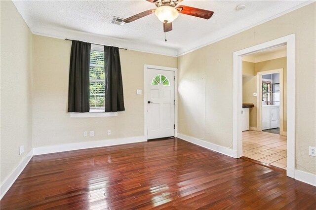 223840 Dante St, New Orleans, LA 70118 - kitchen featuring stainless steel microwave, dark countertops, brown cabinets, and light tile patterned floors
