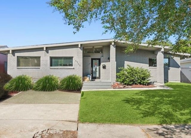 6709 Hastings St, Metairie, LA 70003 - view of front of home with brick siding and a front yard