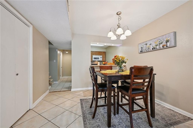 181 Sandra Del Mar Dr Unit 181, Mandeville, LA 70448 - dining space featuring light tile patterned floors and a chandelier