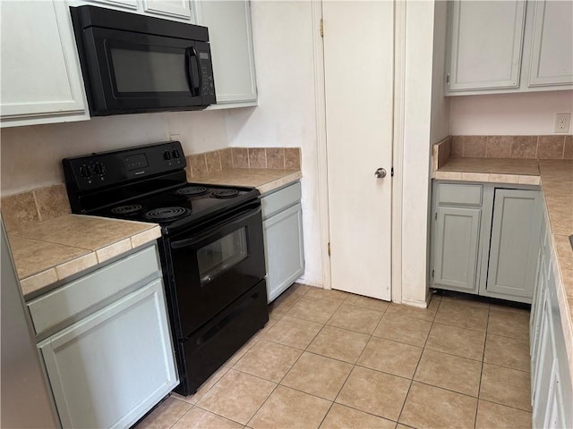 204 Portsmouth Dr, Slidell, LA 70460 - kitchen featuring black appliances and light tile patterned flooring
