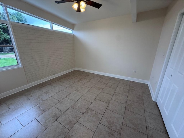 6 Brentwood Dr, Metairie, LA 70003 - spare room with a ceiling fan, tile patterned flooring, and brick wall