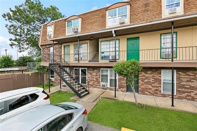 6200 Riverside Dr Unit 625, Metairie, LA 70003 - view of front of house with mansard roof, roof with shingles, brick siding, and cooling unit