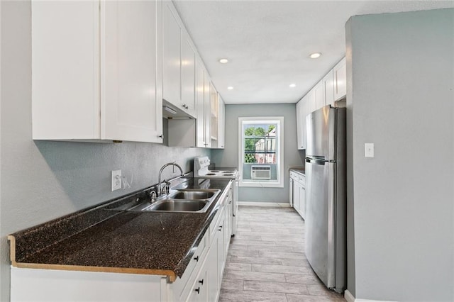 6200 Riverside Dr Unit 625, Metairie, LA 70003 - kitchen with freestanding refrigerator, white electric range, white cabinets, recessed lighting, and light wood-style flooring