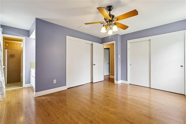761 Holyoke Pl, Terrytown, LA 70056 - unfurnished bedroom featuring wood finished floors, multiple closets, and ceiling fan