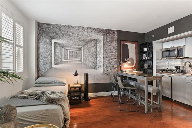 1205 St Charles Ave Unit 704, New Orleans, LA 70130 - interior space featuring wood finished floors and brick wall