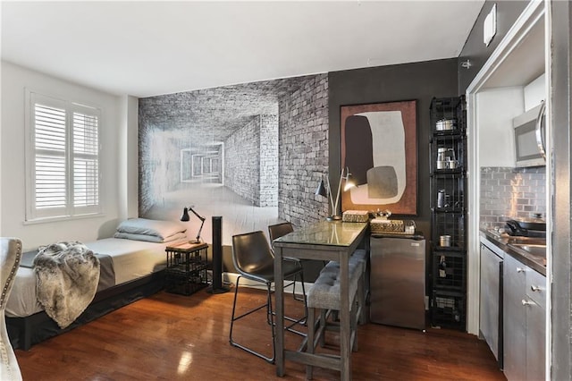 1205 St Charles Ave Unit 704, New Orleans, LA 70130 - bedroom featuring dark wood-type flooring and an accent wall
