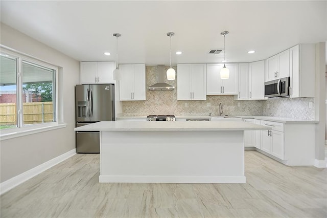 14 Derbes Dr, Gretna, LA 70053 - kitchen with wall chimney range hood, stainless steel appliances, a kitchen island, backsplash, and recessed lighting