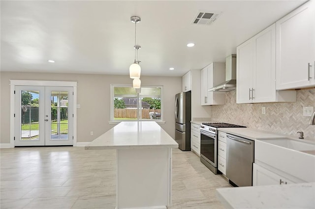 14 Derbes Dr, Gretna, LA 70053 - kitchen featuring wall chimney range hood, stainless steel appliances, healthy amount of natural light, a center island, and recessed lighting