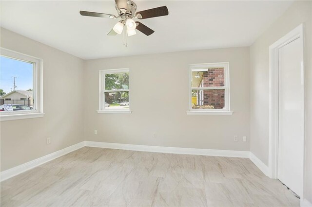 14 Derbes Dr, Gretna, LA 70053 - unfurnished room featuring a ceiling fan and light marble finish floors