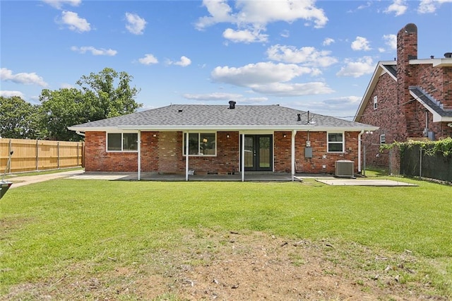 14 Derbes Dr, Gretna, LA 70053 - rear view of property featuring french doors, a patio, a fenced backyard, a shingled roof, and brick siding